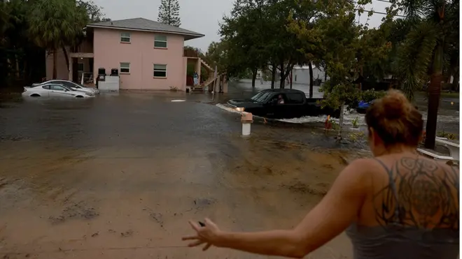 A truck passes through flooded streets caused by Hurricane Idalia passing offshore on 30 August 2023 in Tarpon Springs, Florida