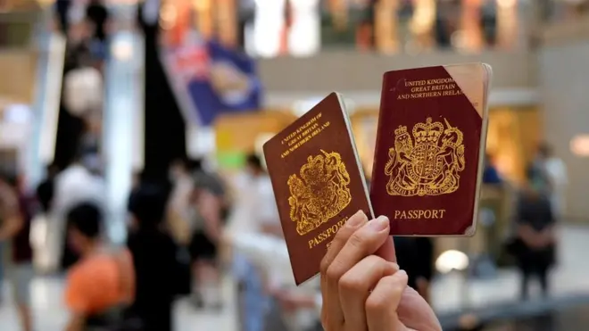 A protester holds two BNO passports