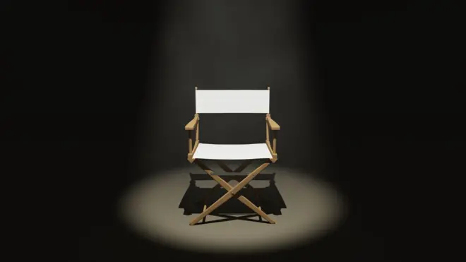 كرسي مخرج تحت الضوء وسط غرفة مظلمة
