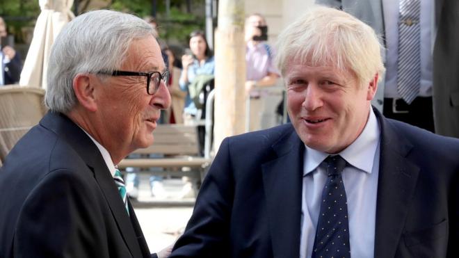 UK Prime Minister Boris Johnson shakes hands with European Commission President Jean-Claude Juncker