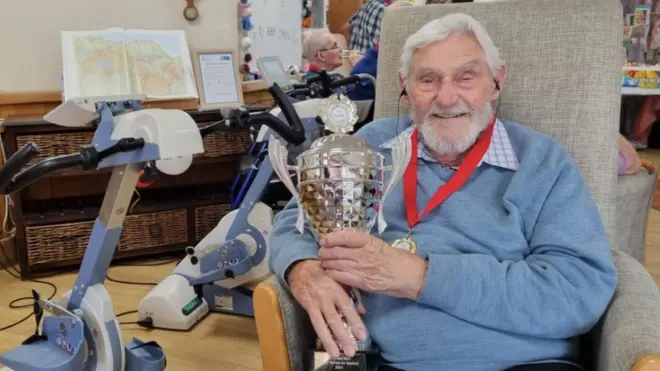 Kenneth Judd with his medal and trophy