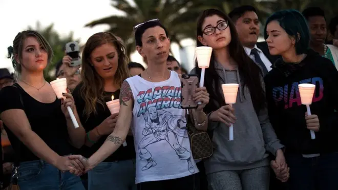 Mourners attend a candlelight vigil at the corner of Sahara Avenue and Las Vegas Boulevard for the victims of Sunday night's mass shooting (2 October)