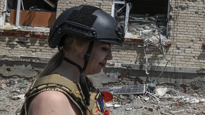 Image shows woman in army gear