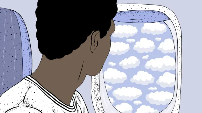 Young man looking out of aeroplane window