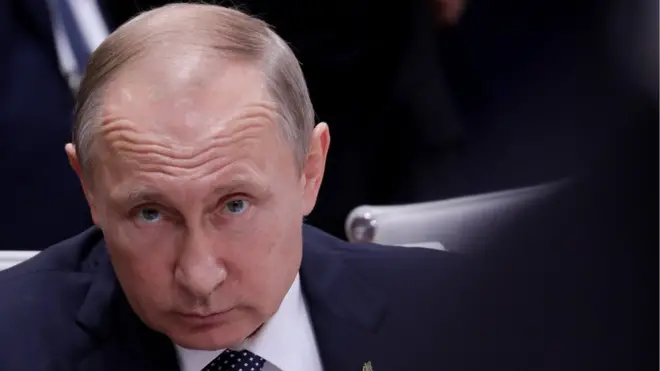 Vladimir Putin looks directly at the camera