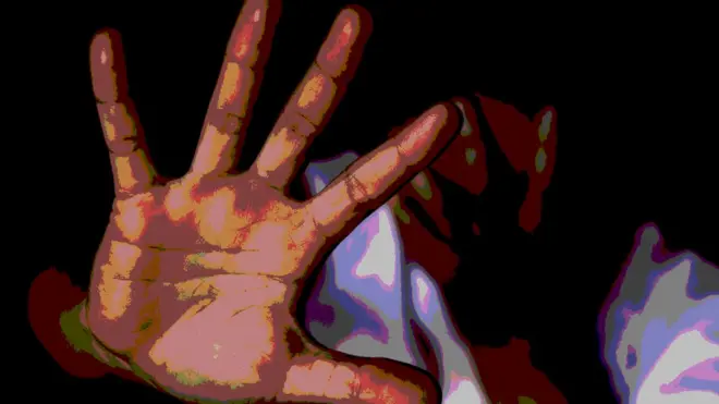 A Photoshopped image showing a woman covering her face and holding up her other hand