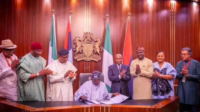 Nigeria President sign NIMC Act into law, oda top officials stand wit am
