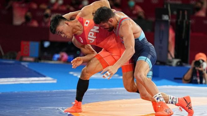 Silver medalist Kenichiro Fumita of Japan (red) in action with gold medalist Luis Alberto Orta Canchez of Cuba (blue) for the Men's Greco-Roman 60kg Final Match of the Tokyo 2020 Olympic Games at the Makuhari Messe convention centre in Chiba, Japan, 02 August 2021.