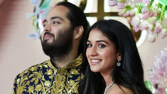 Anant Ambani, son of businessman Mukesh Ambani, poses with his fiance Radhika Merchant on the red carpet during the sangeet ceremony at Jio World Centre, Mumbai, India, July 5, 202