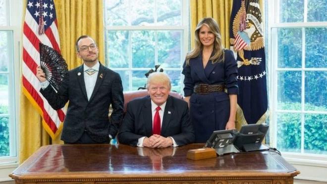 Nikos Giannopoulos with Donald and Melania Trump. and a flag