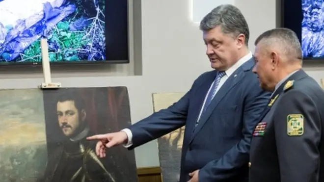 Ukrainian President Petro Poroshenko looks at the recovered paintings. 11 May 2016