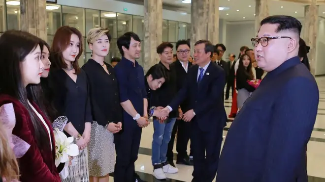 Kim Jong-un tampak berbincang-bincang dengan para artis dari Korea Selatan di sela-sela konser mereka di Pyongyang.