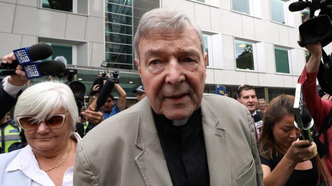 George Pell followed by media as he leaves a Melbourne courtroom on Tuesday after a reporting ban on his conviction was lifted