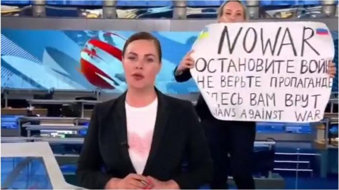 Protester on set of the 'Vremya' news programme