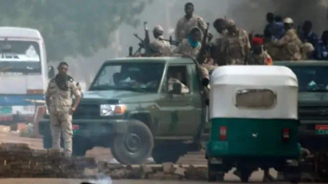 Sudanese security forces, seen here on Monday, have moved against the protesters after a long stand-off