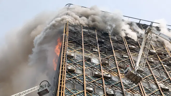 Smoke pours from the Plasco building in Tehran, Iran, shortly before it collapses (19 January 2017)
