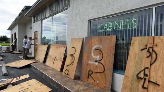 Windows of shop front boarded up ahead of Hurricane Matthew on Cocoa Beach, Florida on October 5, 2016