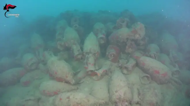 Dozens of barnacle-crusted jars seen on the sea bed