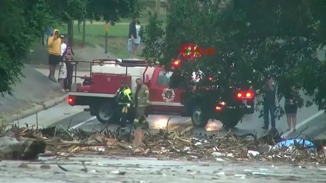 Red emergency vehicle infront of flooded road.