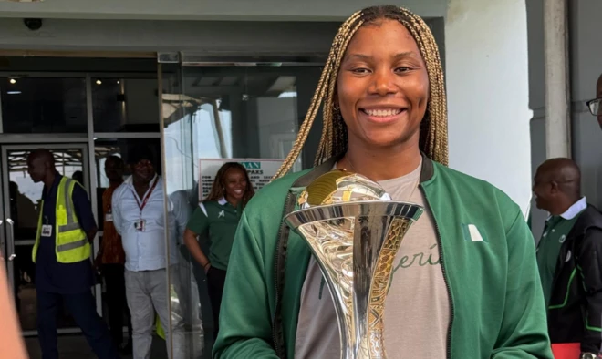 Nigeria D'Tigress player posing with the AfroBasket trophy