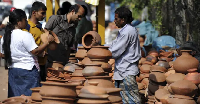 A Sri Lankan vendor sorts clay pots in Colombo