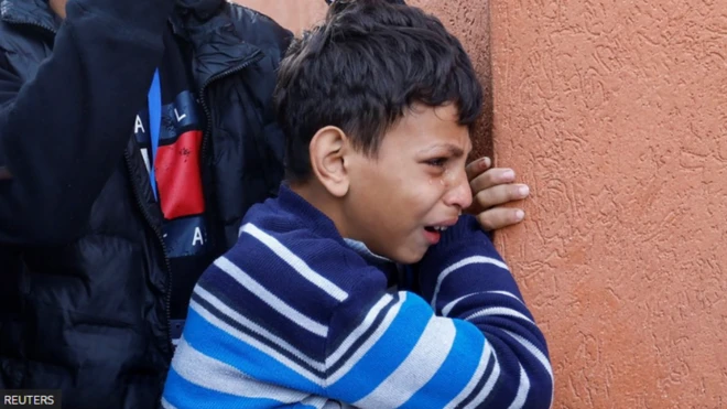 A Palestinian boy reacts, as he attends the funeral of Palestinians killed in an Israeli raid, amid the ongoing conflict between Israel and the Palestinian Islamist group Hamas at Nasser hospital in Khan Younis, in the southern Gaza Strip.