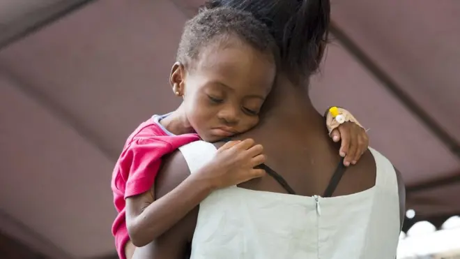 A woman holds her child at the Princess Marie Louise Children’s Hospital