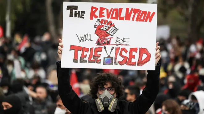 A person holds a placard, during a protest on the day Istanbul Mayor Ekrem Imamoglu was jailed as part of a corruption investigation, in Istanbul, Turkey, on 23 March 2025