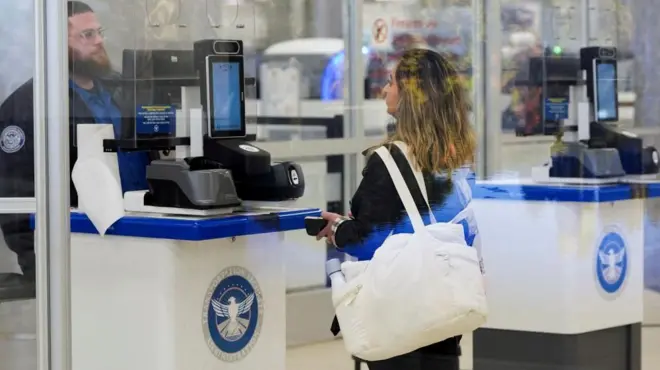  A person gets checked in by a TSA agent at a security counter at Hartsfield-Jackson Atlanta International Airport
