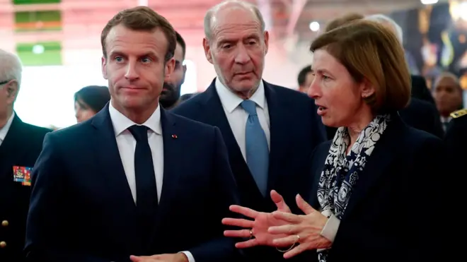 French President Emmanuel Macron (C) and and French Minister of the Armed Forces Florence Parly (R) visit a stand at Euronaval, the world naval defence exhibition in Le Bourget near Paris, France, October 23, 2018.