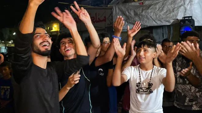 Palestinians celebrate on a street in Khan Younis after Trump's announcement.