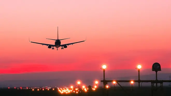 Plane taking off at sunset