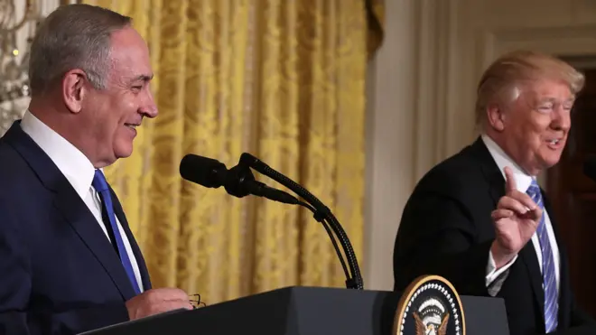 US President Donald Trump (R) and Israel Prime Minister Benjamin Netanyahu (L) shake hands during a joint news conference at the East Room of the White House