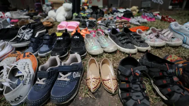 Children's shoes left at the base of a vigil