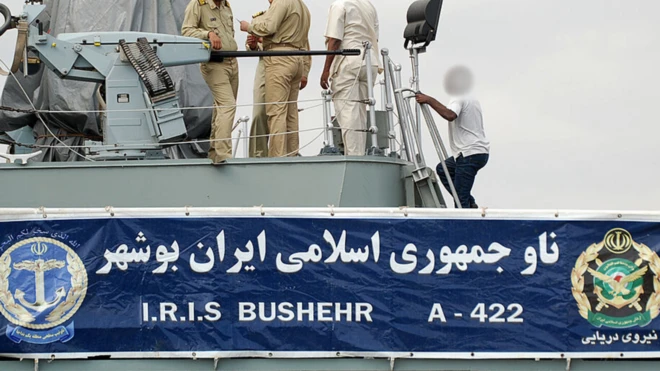 Iranian navy personnel stand aboard the IRIS Bushehr as two Iranian warships docked in the Sudanese Red Sea city of Port Sudan on December 8, 2012. 