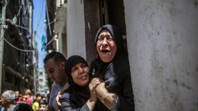 Grandmother of 15-year-old Mahmud Tolba, who was killed in Israeli air strike, mourns during his funeral in Al Zaitun neighborhood in the east of Gaza City