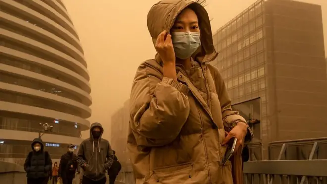 عاصفة رملية تحول السماء في العاصمة الصينية بكين إلى اللون البرتقالي مما تسبب في وقف مئات الرحلات الجوية وارتفاع هائل في قياسات تلوث الهواء.