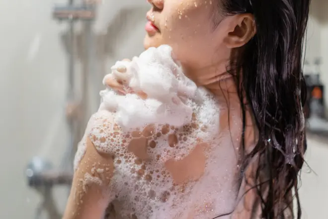 Woman bathing and washing her hair relaxed
