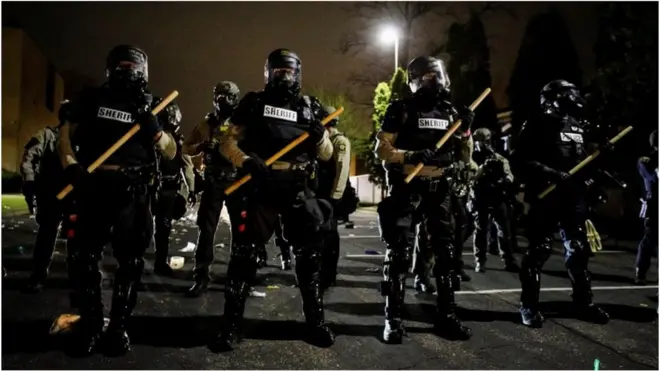 Officers stand guard outside Brooklyn Center Police Department