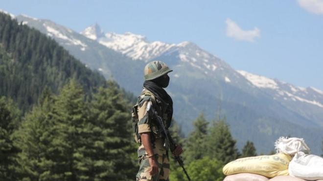 an Indian paramilitary soldier stands guard at check post along a highway leading to Ladakh, at Gagangeer some 81 kilometers from Srinagar, the summer capital of Indian Kashmir, 17 June 2020.