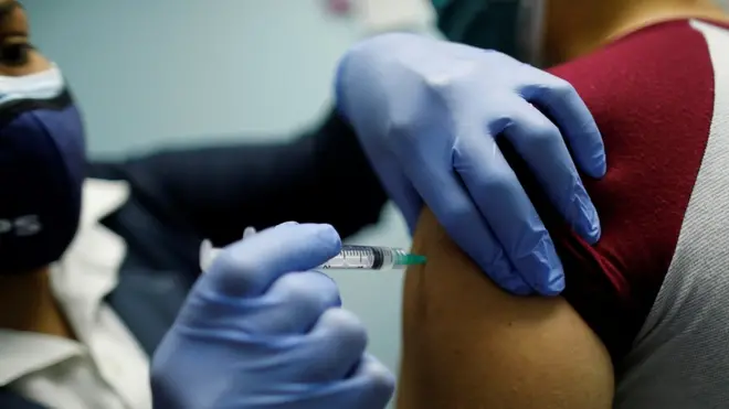 A woman receives a dose of the China"s Sinopharm coronavirus disease (COVID-19) vaccine at a health center in Caracas, Venezuela March 7, 2021.