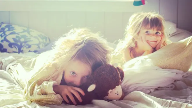 Two girls waking up