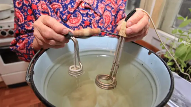 люди кипятят воду в ведрах