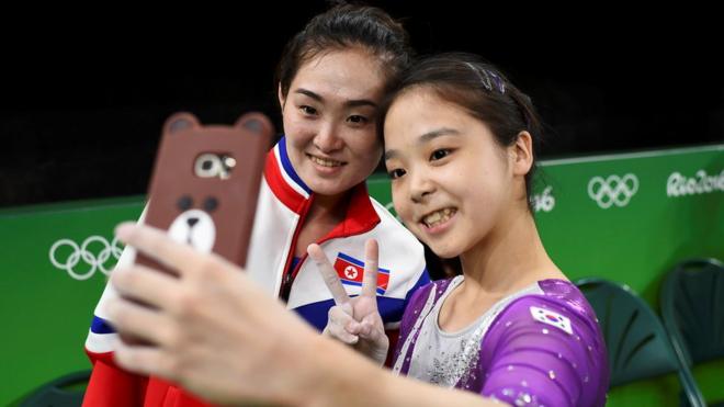 Lee Eun-Ju (KOR) of South Korea (R) takes a selfie picture with Hong Un Jong (PRK) of North Korea