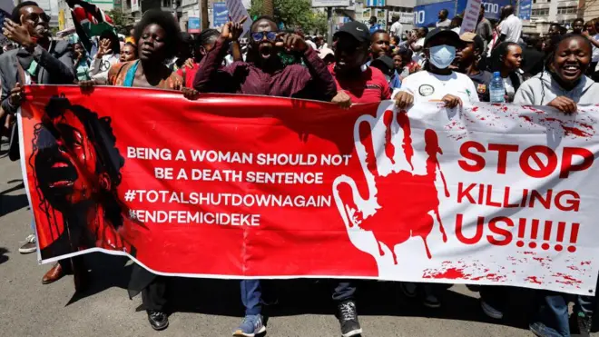 Protesters carry placrds as dem dey march against femicide and gender based violence for Kenya 