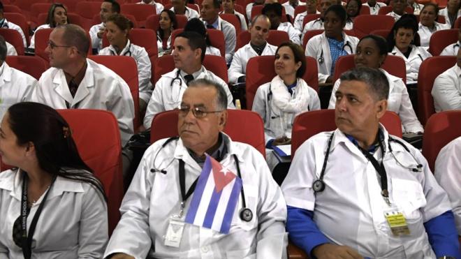 Some 100 Cuban doctors follow proceedings during their induction programme at the Kenya School of Government, on June 11, 2018 in Nairobi. - The doctors will be posted to various hospitals in Kenya's 47 counties. Each county is expected to get at least two doctors