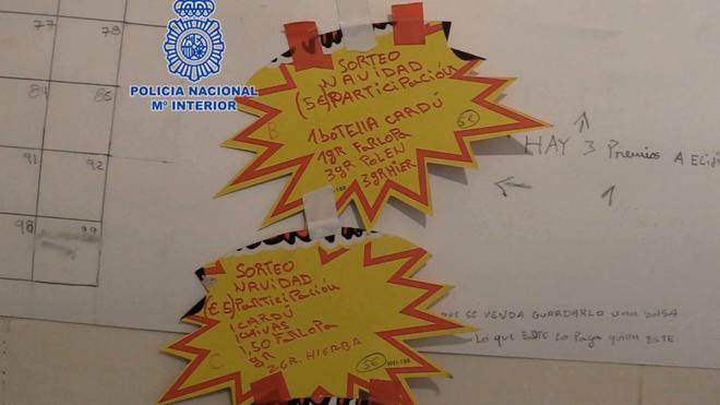 Two yellow stickers announce the raffles for two narco-hampers in Murcia.