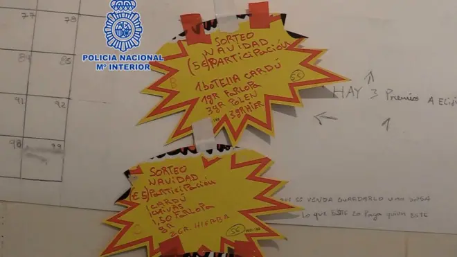 Two yellow stickers announce the raffles for two narco-hampers in Murcia.