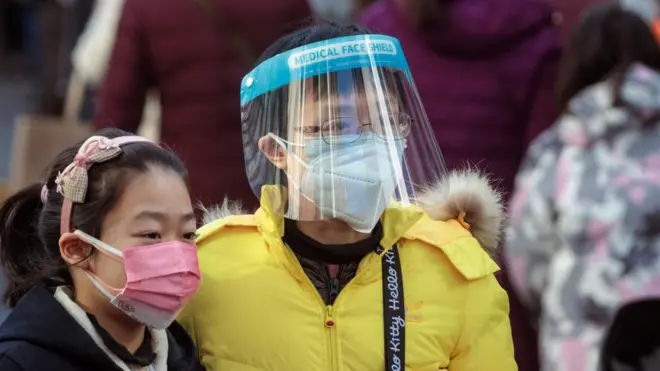 People wearing face masks on the streets of Shanghai, China.