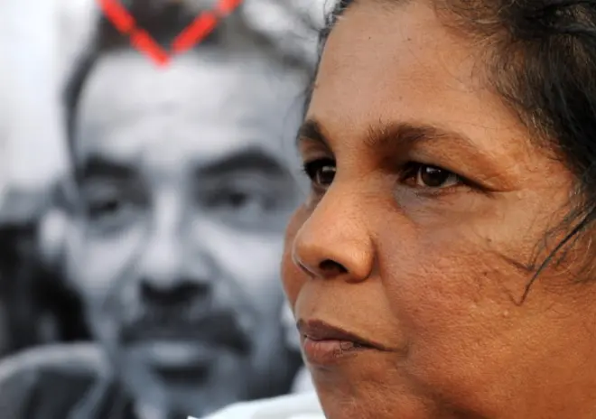 Sandhya Eknaligoda wife of missing Sri Lankan cartoonist and journalist Prageeth Eknaligoda holds up a placard bearing his image during a protest rally in Colombo on January 24, 2012. Prageeth Eknaligoda disappeared on January 24, 2010, just hours before the presidential election. Rights groups have repeatedly accused the government of stifling media freedoms, a charge denied by the authorities